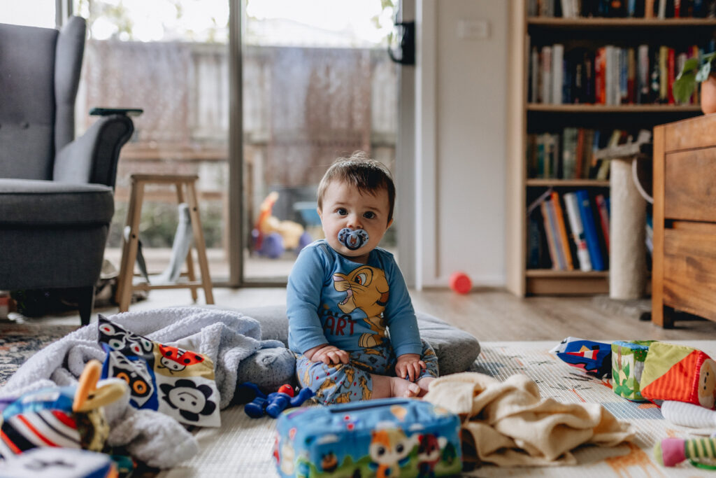 Baby sitting among toys