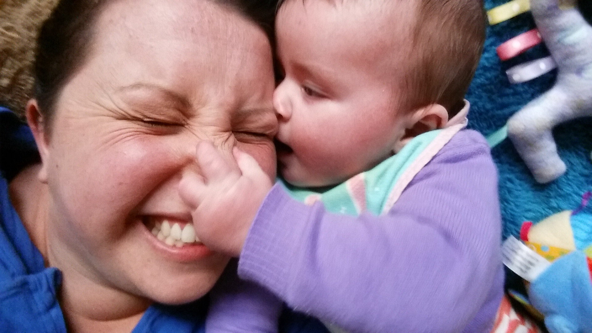 child pulling on mother's nose. Lessons from motherhood.