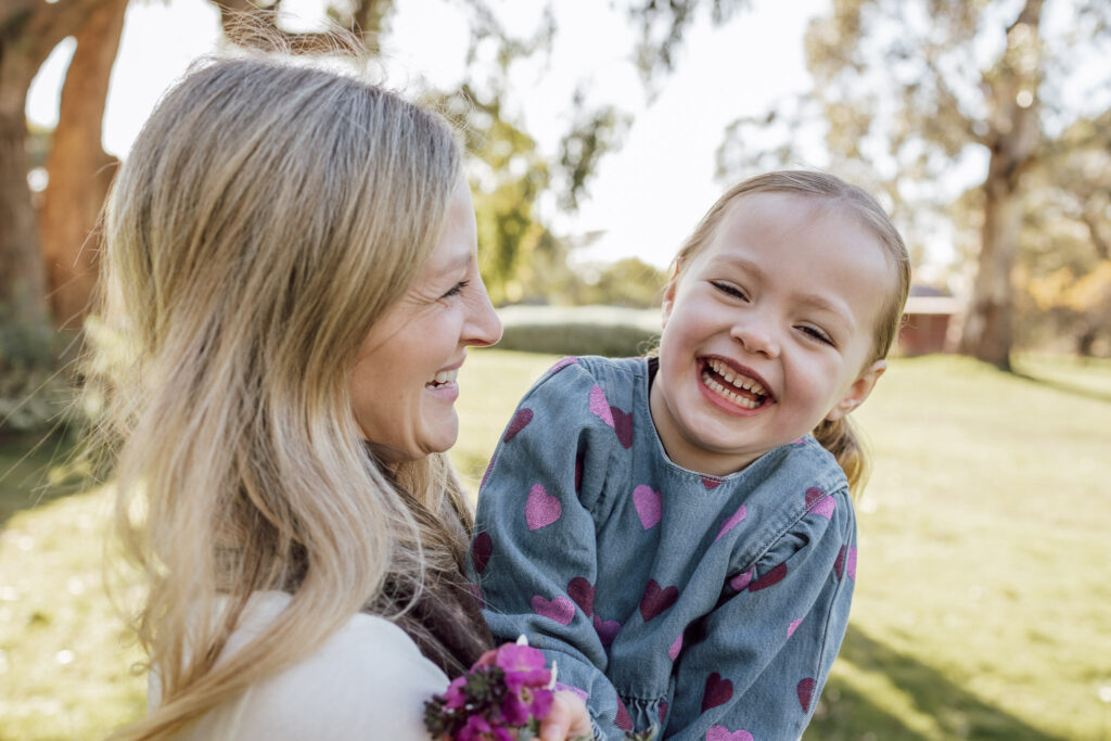 Mum and daughter laughing together.